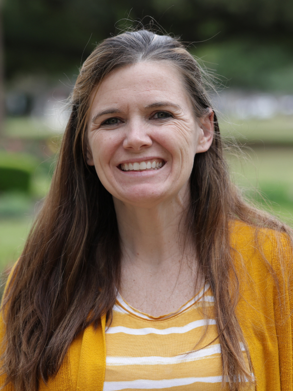 view of a brunette woman wearing a yellow striped shirt